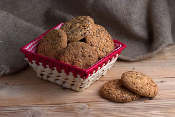 homemade oat cookies with sunflower seeds in basket on wooden table