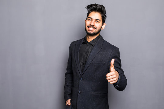 Portrait Of Excited Indian Man Dressed In Formal Wear Giving Thumbs-up Against Gray Background