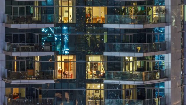 Scenic glowing windows of skyscrapers at evening timelapse