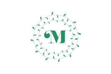  Letter M logo with round green leaves. Elegant floral monogram template design.