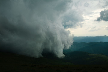 Gray storm windy clouds in mountains