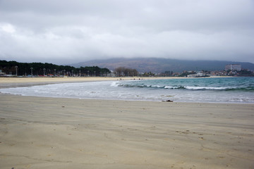Waves on Samil beach during cloudy day, Vigo, Galicia, Spain