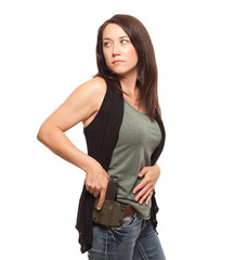 Woman looking over her shoulder with hand on gun.