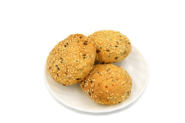 Rolls with sesame and raisin on white background