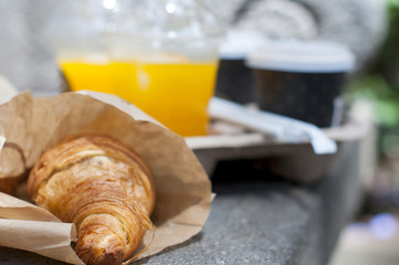 Croissant breakfast with coffee and orange juice to take away