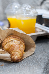 Croissant breakfast with coffee and orange juice to take away