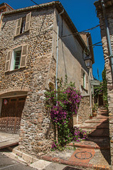 View of alley with house on the slope and flowers in Haut-de-Cagnes, a pleasant village on top of a hill. Located in the Alpes-Maritimes department, Provence region 