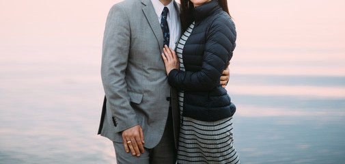 Fototapeta na wymiar beautiful adult couple hugging on the sunset businessman and woman