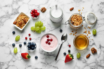 Obraz na płótnie Canvas Flat lay composition with tasty yogurt for breakfast on marble background