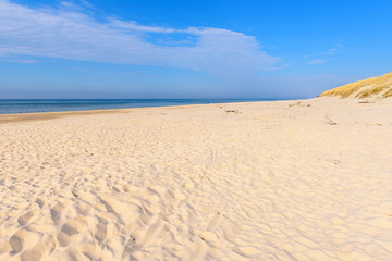 Fototapeta na wymiar White sand and beautiful Baltic Sea in sunny day. Poland
