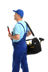 Mature plumber with pipe wrench and tool bag on white background