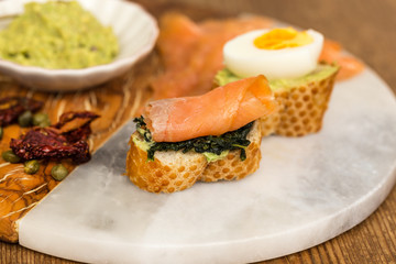 Healthy breakfast. Toasts with spinach, boiled egg and smoked sa