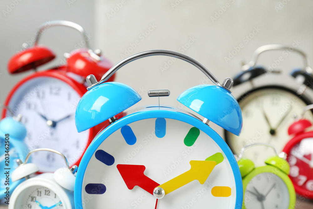 Poster blue alarm clock and many others on background. time change concept