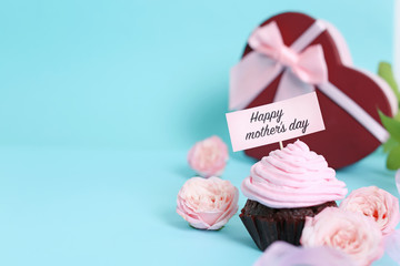 Festive surprise with tasty treat for Mother's Day on color background