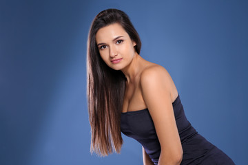 Portrait of beautiful model with gorgeous straight hair on color background