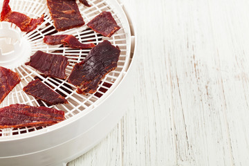 Homemade Beef Jerky in a Dehydrator. Selective focus.