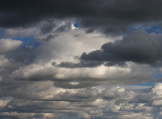 Cloudy sky background with white clouds and some gray cloud