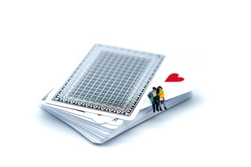 Miniature people : Couple of love sitting on playing card,Lover concept.