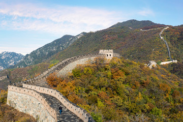 Fototapeta na wymiar China The great wall distant view compressed towers and wall segments autumn season in mountains near Beijing ancient chinese fortification military landmark in Beijing, China.