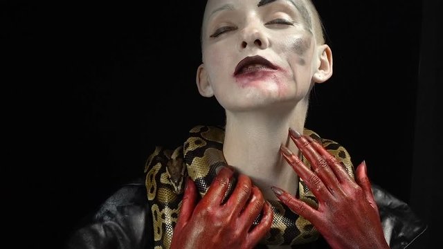 Gentle snake and woman with bloody hands
