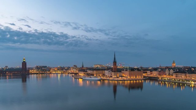 Stockholm city skyline day to night sunset timelapse at Stockholm City Hall and Gamla Stan, Stockholm Sweden 4K Time Lapse