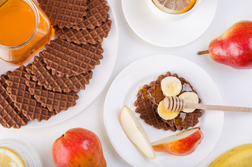 Chocolate waffles with honey and banana.