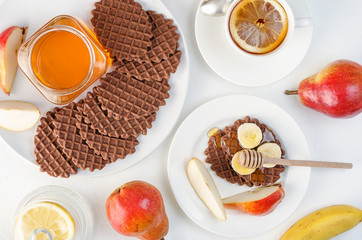 Chocolate waffles with honey and banana.