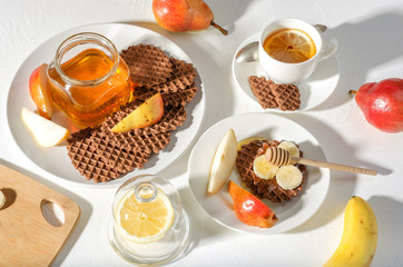 Chocolate waffles with honey and banana.