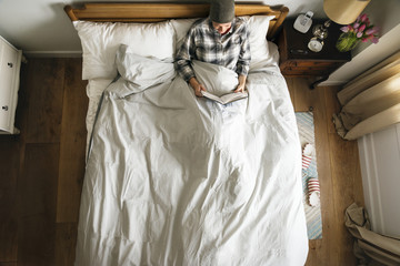 Patient reading in bed