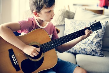 Young boy playing guitar