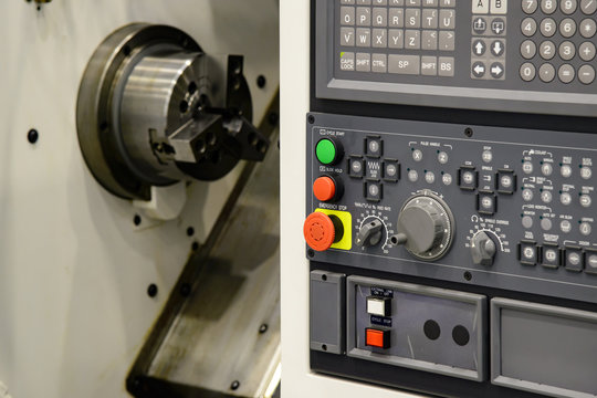 The  CNC lathe or turning  machine with the controller board.The  modern machining process.