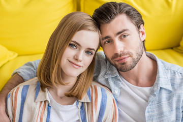 portrait of young man embracing attractive girlfriend