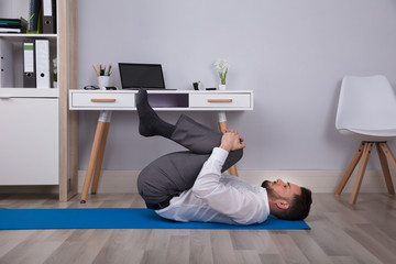 Side View Of A Businessman Doing Exercise
