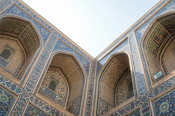 The arch and the exterior design of the ancient Registan in Samarkand. Ancient architecture of Central Asia