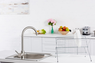 close up of sink and stand for dishes on kitchen