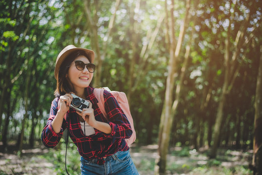 Beauty Asian woman smiling lifestyle portrait of pretty young woman having fun in outdoors summer with digital camera. Traveling of photographer concept. Hipster style and Solo woman theme.