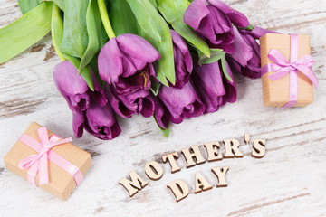 Purple tulips and gifts for mother's day on boards