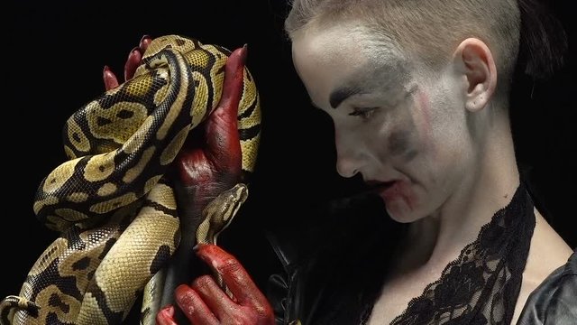 Woman and snake looking at each other