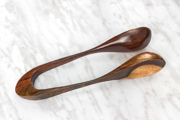 Wooden musical spoons on marble background