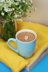 Blue Cup of Coffee Milk Latte Drink Cinnamon Sticks Wooden Background Yellow Napkin Rustic Camomile Flower Buquet Flat Lay