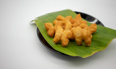 Pa Thong Ko, pairs of connected dough  fried sticks, on banana leaf.