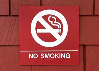 Red square sign with no smoking in white, cigarette with circle around line through as a pictorial...