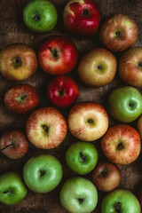 top view of different apples on rustic wooden table