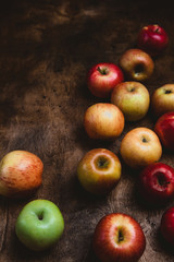 closeup shot of pile of apples on rustic wooden table