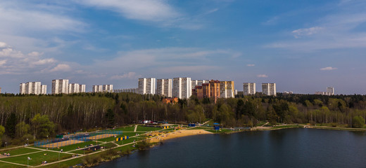 Fototapeta na wymiar houses on bank of pond in Zelenograd, Russia