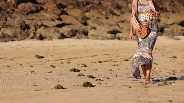 Woman with fashionable stylish rattan bag on the beach. Tropical island of Bali. Handmade Rattan eco handbag HD footage.