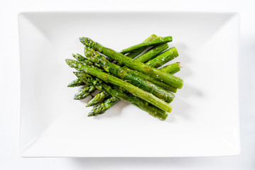 roasted asparagus on white plate