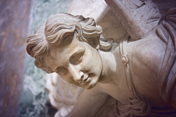 A marble statue of an angel holdintg a font at the entrance of the church of Casa Professa, Chiesa...