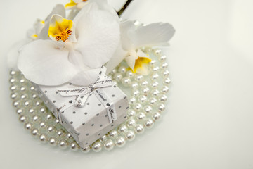 Obraz na płótnie Canvas Gift box and white orchid on a white background 