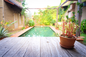 Flowerpot on wooden table, Background for vintage resort hotel